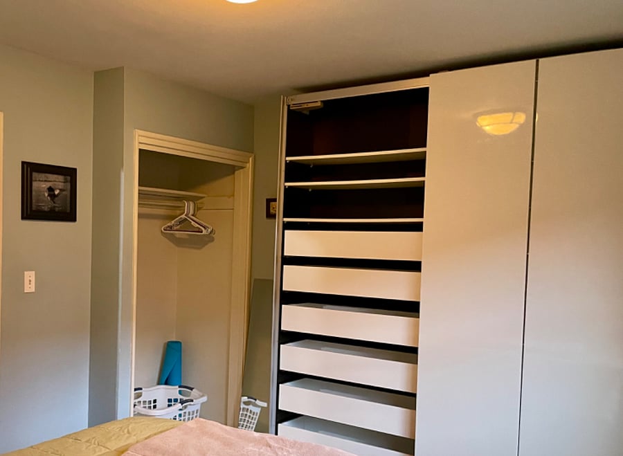 So much bedroom storage! A regular size closet for hanging clothes, plus a floor to ceiling closet with drawers on the left side and shelves on the right.