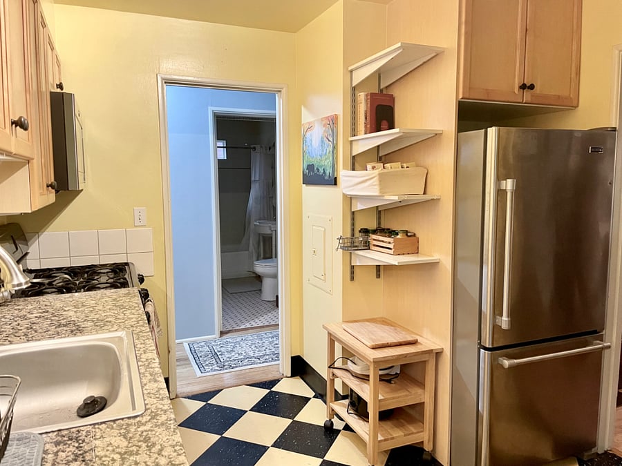 The kitchen also has a large refrigerator/freezer and appliances like a crock pot, electric kettle, waffle maker, smoothie maker, and hand mixer.