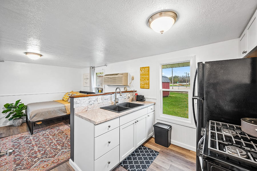 Fully stocked kitchen with full size appliances - sink, refrigerator, stove/oven, microwave, coffee pot, blender, toaster all new in each home.