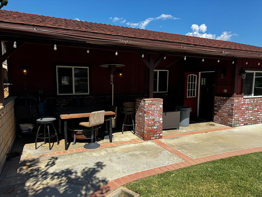 Front porch with fire pit and BBQ and portable heater. 