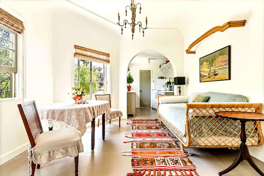 Lower mother in law guest quarters - Bright and airy Dining area / work station and daybed seating with a view of the kitchen beyond the archway.