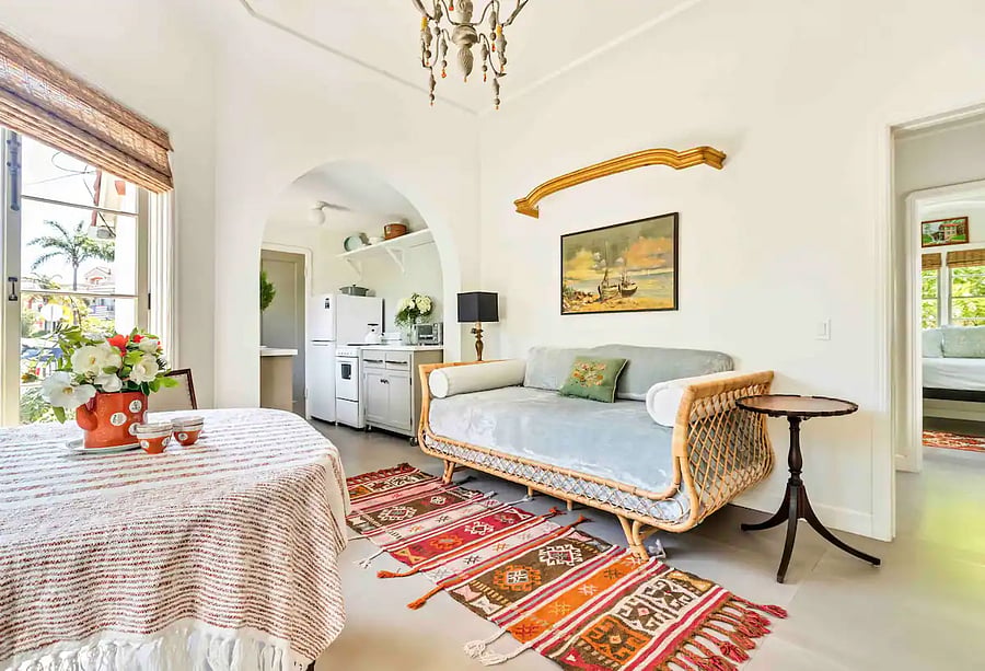 Lower mother in law guest quarters - Bright and airy Dining area / work station and daybed seating with a view of the kitchen beyond the archway.