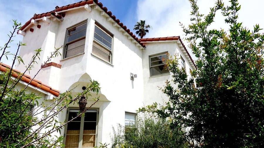 View of large corner windows in upper mother in law guest quarters from Palm Ave.