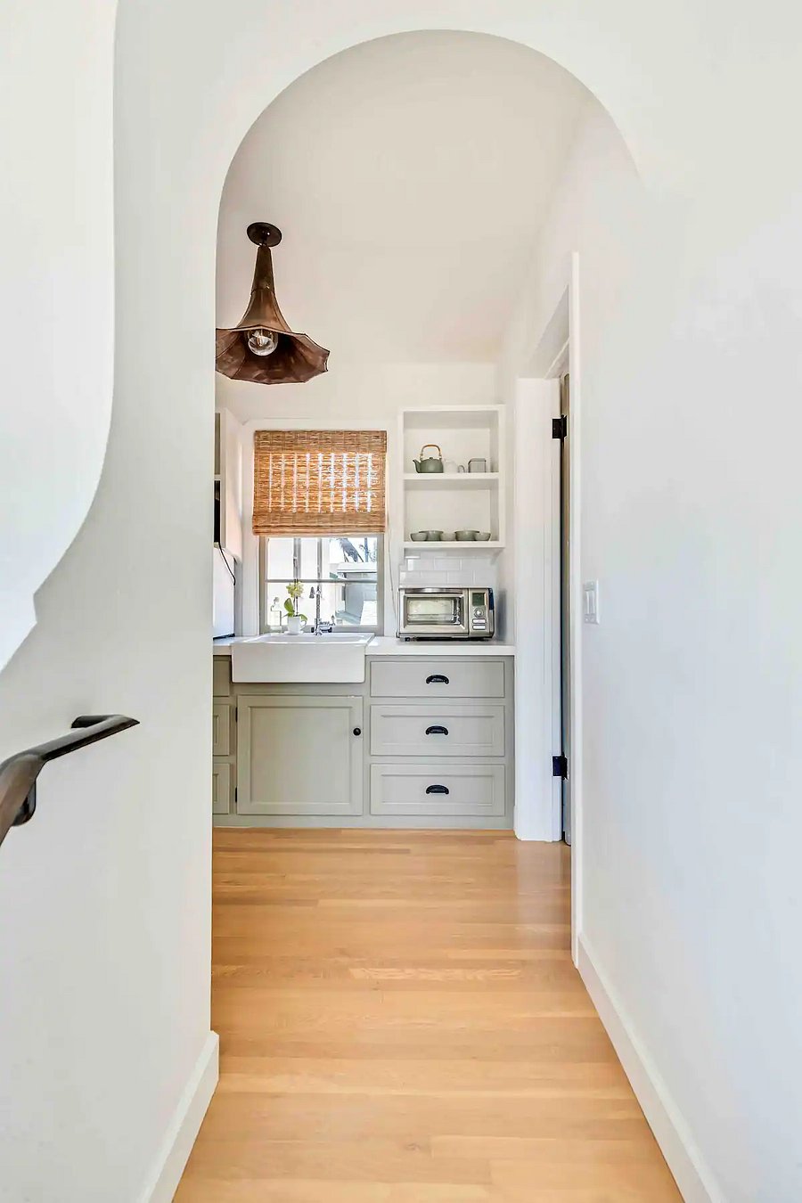 Stair landing at upper mother in law guest quarters with a view of kitchenette.
