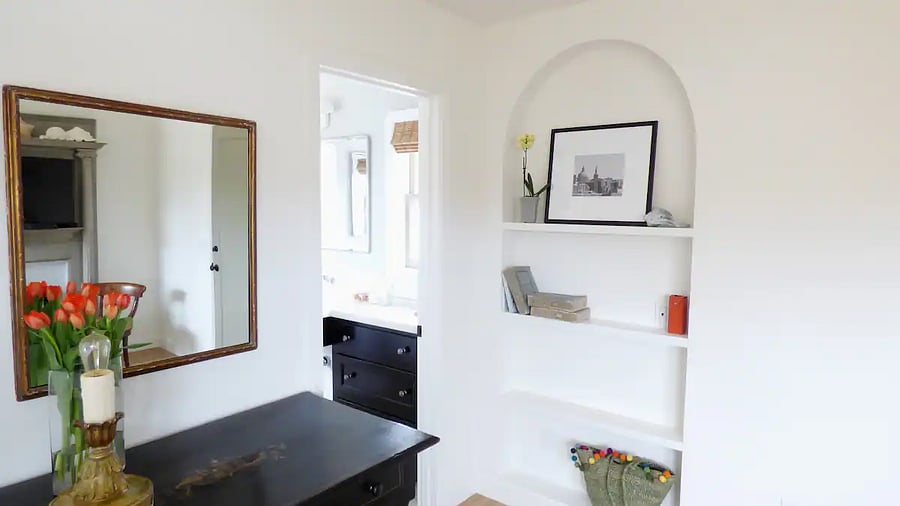 Arched bookcase (charging station) with door leading to ensuite bathroom at upper mother in law guest quarters.
