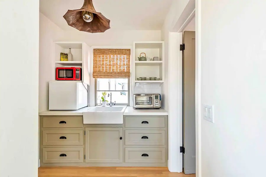 Kitchenette at open landing, with counter oven and refrigerator and a second (under cabinet) refrigerator.
