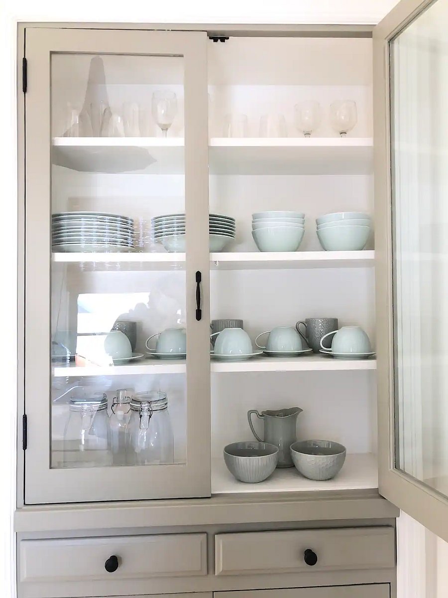 Serving porcelain dishes in an antique china cabinet at the open landing kitchenette in upper mother in law guest quarters.
