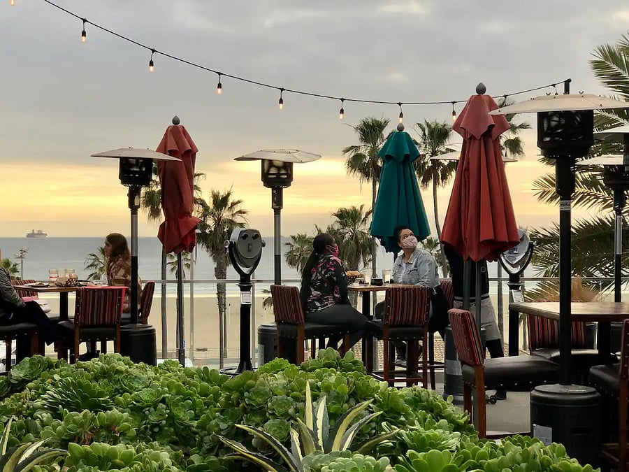 Enjoy restaurants at PACIFIC CITY outdoor mall with a view of the ocean and the pier.