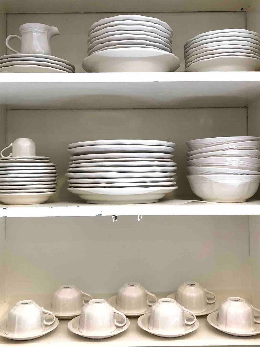 Serving dishes inside kitchen cabinet in the Main house.