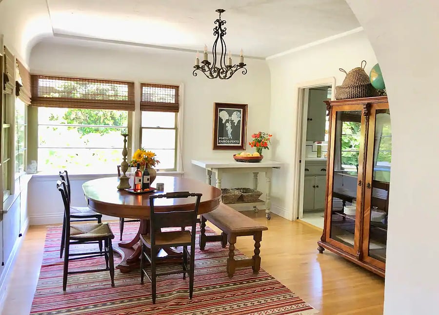 Main house - formal Dining room with large corner windows that let in morning sunlight and ocean breezes (table comes with 6 to 8 chairs)