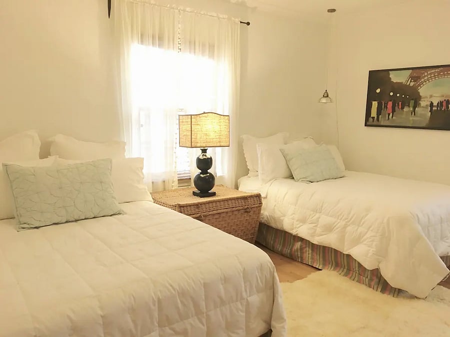 Another view of Master bedroom suite 1 with two full beds (in winter down comforters), in the main house.