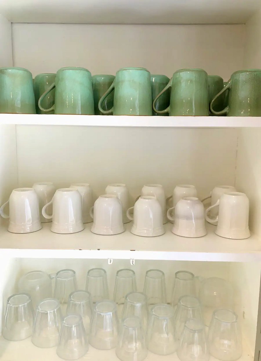 Cups and glasses inside kitchen cabinet in the Main house.