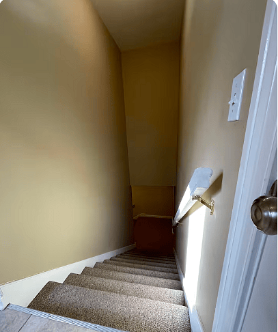 Top of first floor stairs to the basement/entertainment room.