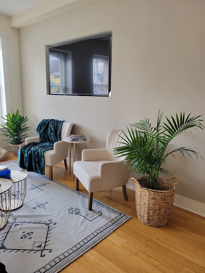 living room with mounted 55 inch smart tv