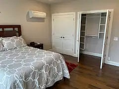 Bedroom 1 has a comfy queen bed and huge double closet with shelves, desk.