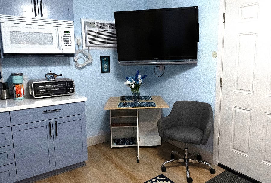 Large TV with Firestick and dining table/desk.