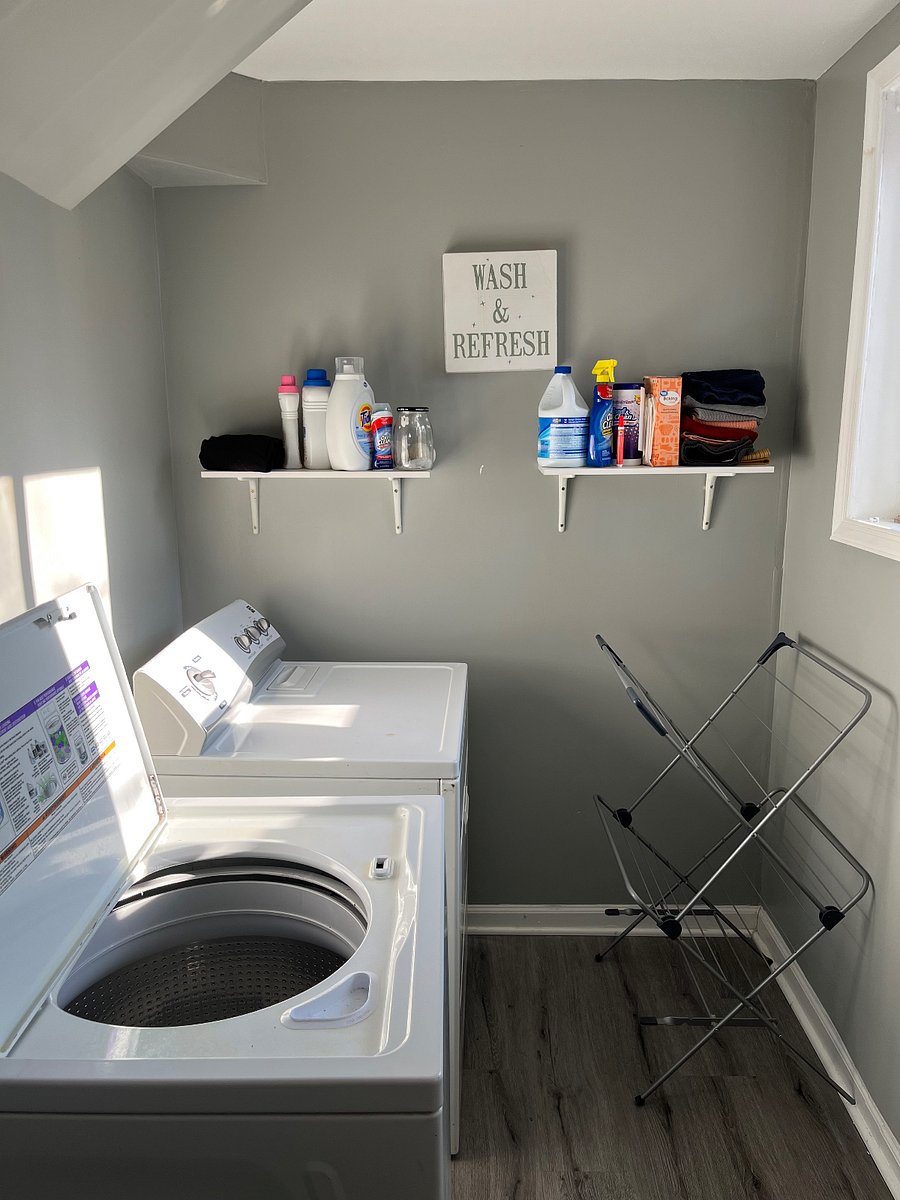 Shared laundry room with washer, dryer, and drying rack
