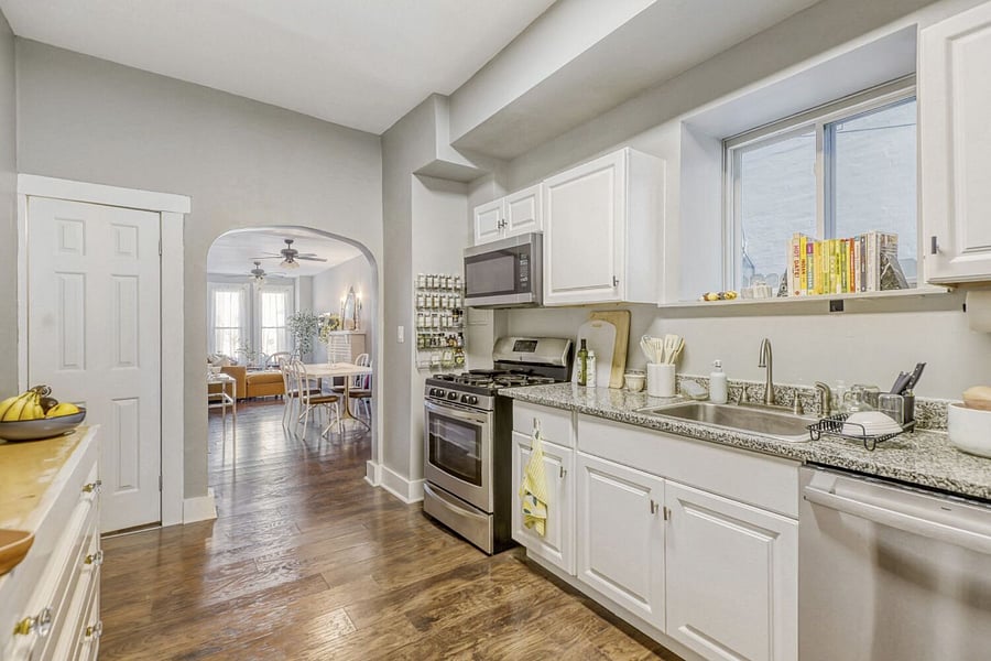 Shared kitchen with dishwasher! White door is entrance to this furnished studio