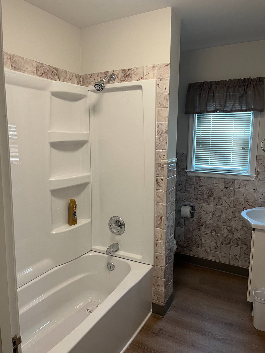 Full bath with tub/shower combination.