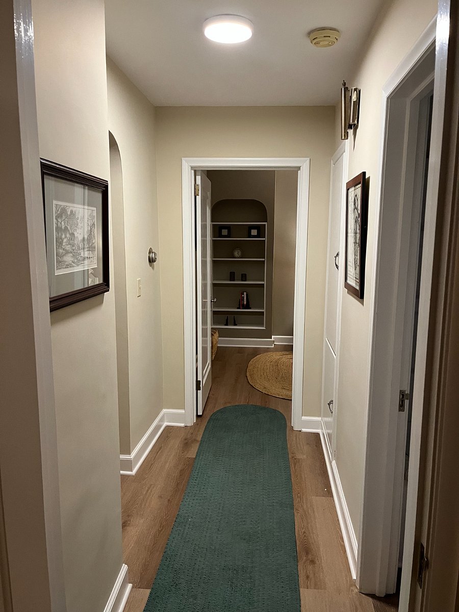 Hallway with built-in wall storage.