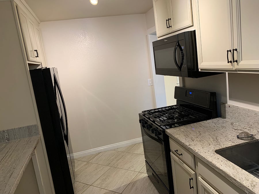 Kitchen - facing the stove and microwave oven - granite counter tops