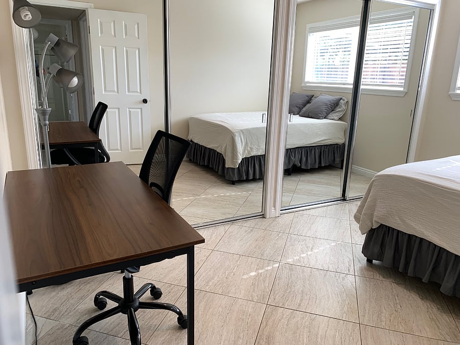 Second bedroom - full size bed, floor to ceiling mirror, extra large closet with ample storage, and desk/chair.