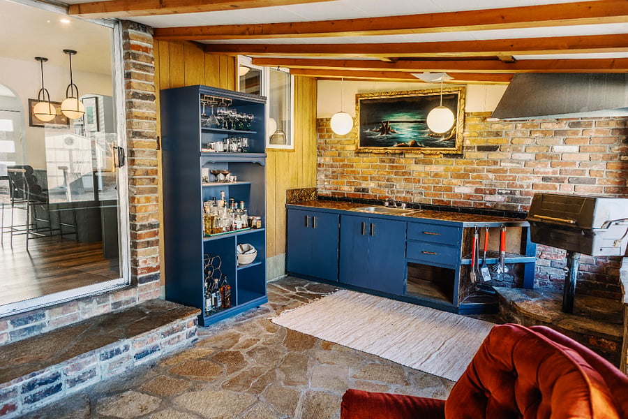 Back room bar and sink with indoor gas grill for BBQing.