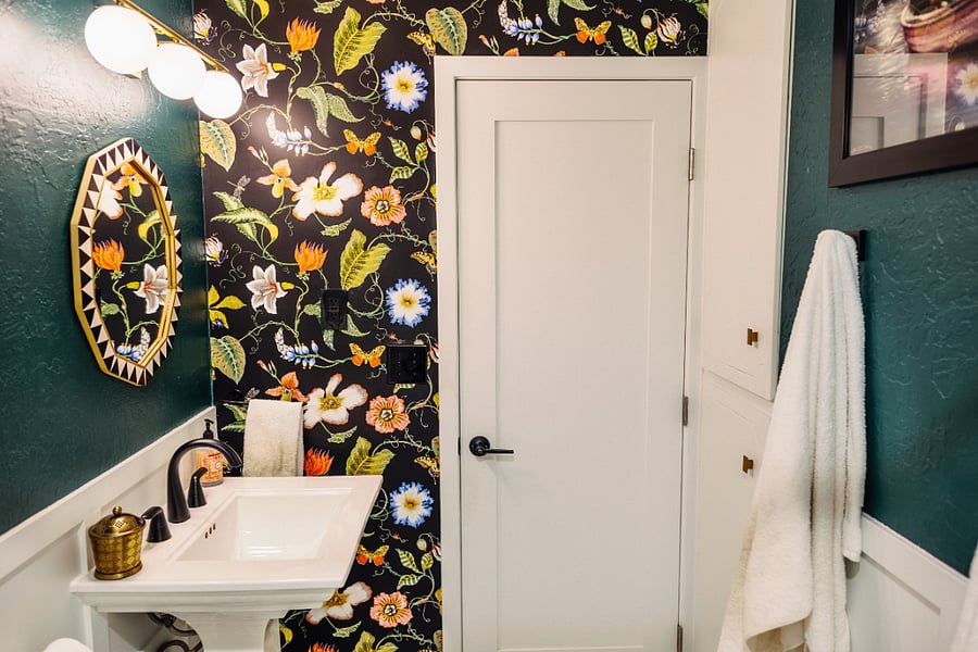 Hallway bathroom with built-in closets for storage.