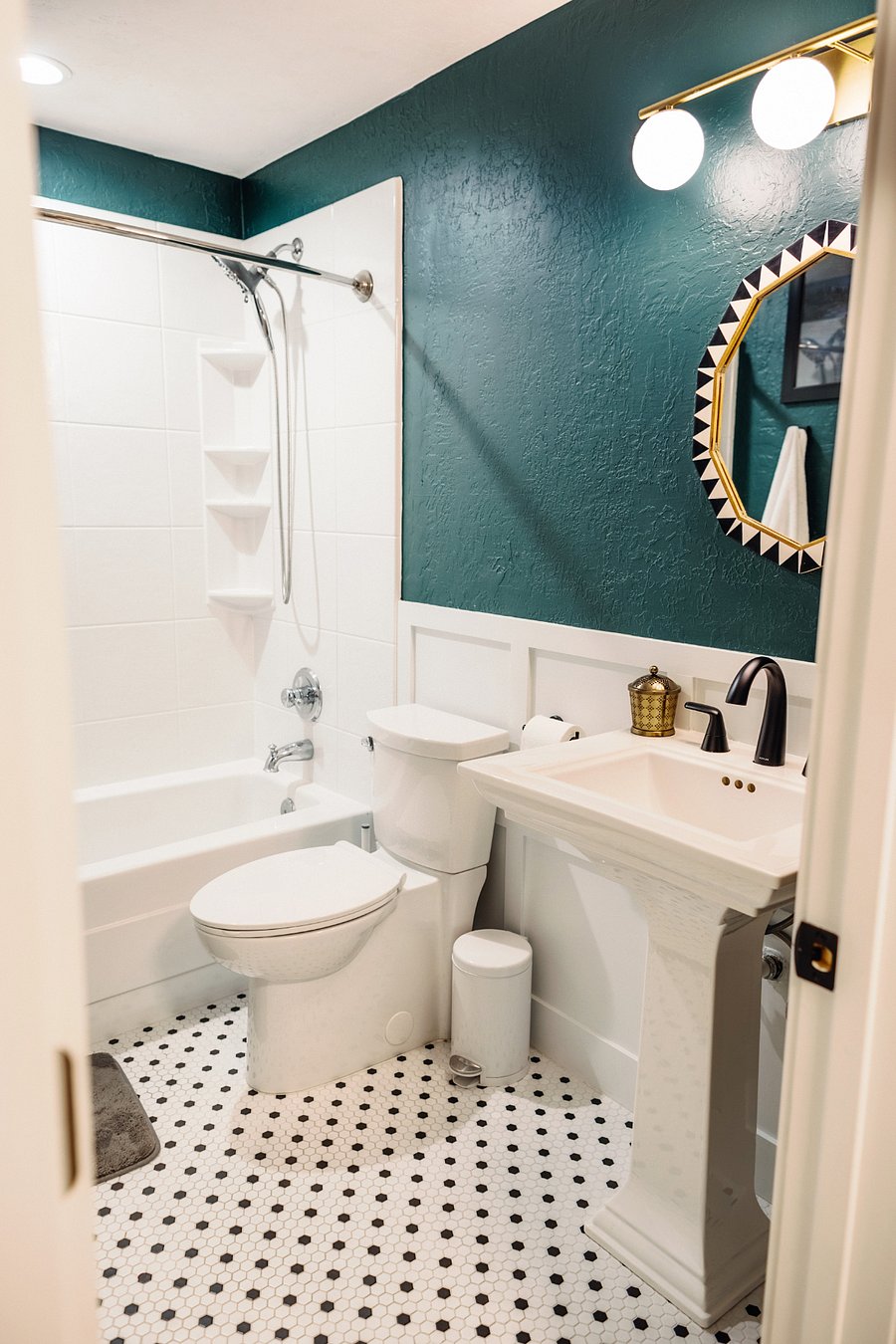 Hallway bathroom and bath tub.