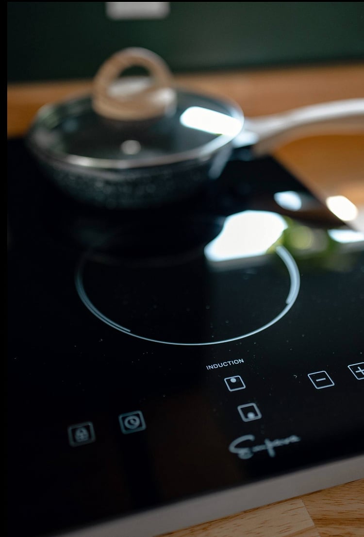 This induction cooktop lives in the cabinet, and can be plugged in for use.