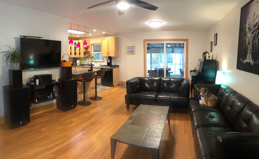 Spacious living area with 50" smart TV, piano, and stereo