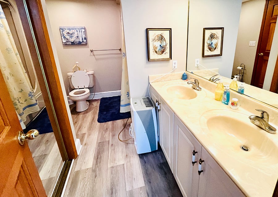 Full bathroom with tub and shower, double sinks, and more closet space.