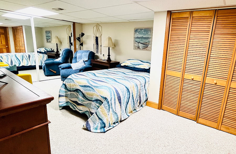 Huge relaxing bedroom with queen bed, large closets, a sitting area, and a smart tv.  No windows in the bedroom make for some really  amazing sleep!