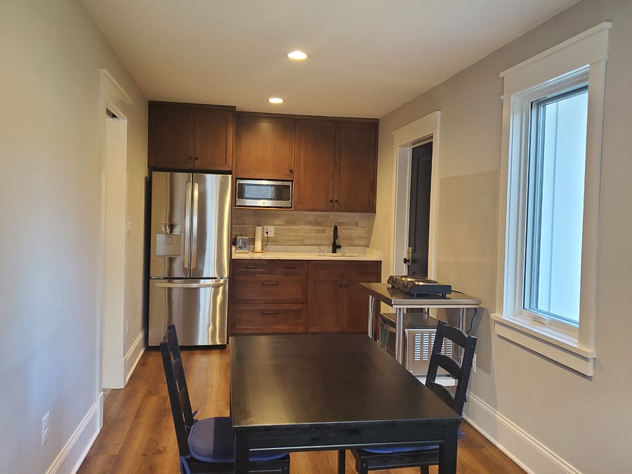 Kitchenette with full-sized refrigerator, quartz countertops, microwave, toaster oven