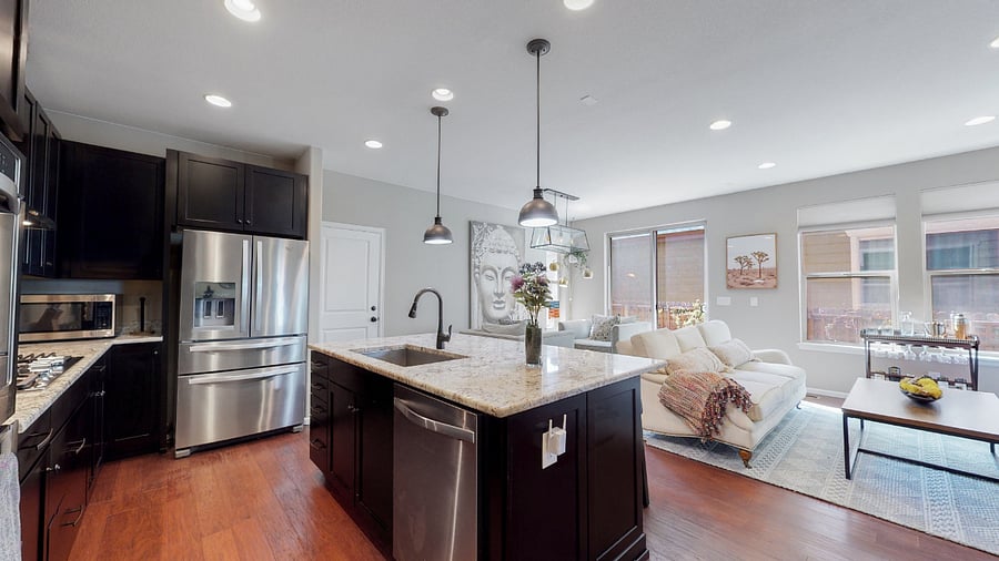 Ground level living room with stainless steel appliances, drip and French press coffee makers.