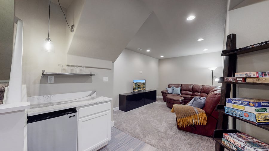 Small fridge in basement living room.