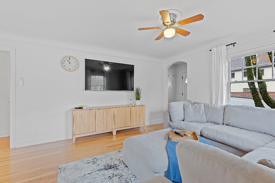 Living room w/ large sectional and Smart TV