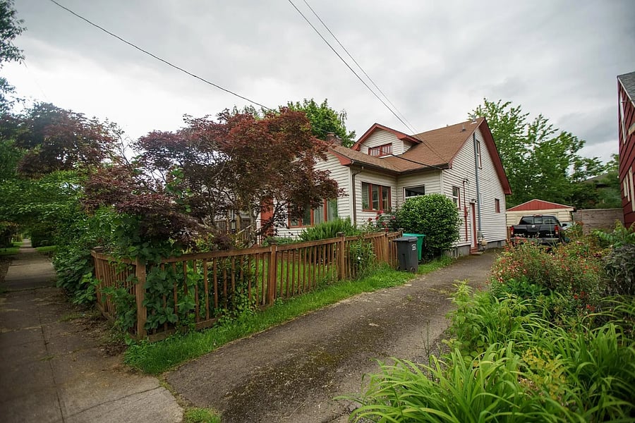Tenant walks to apartment by entering driveway and using side door. 