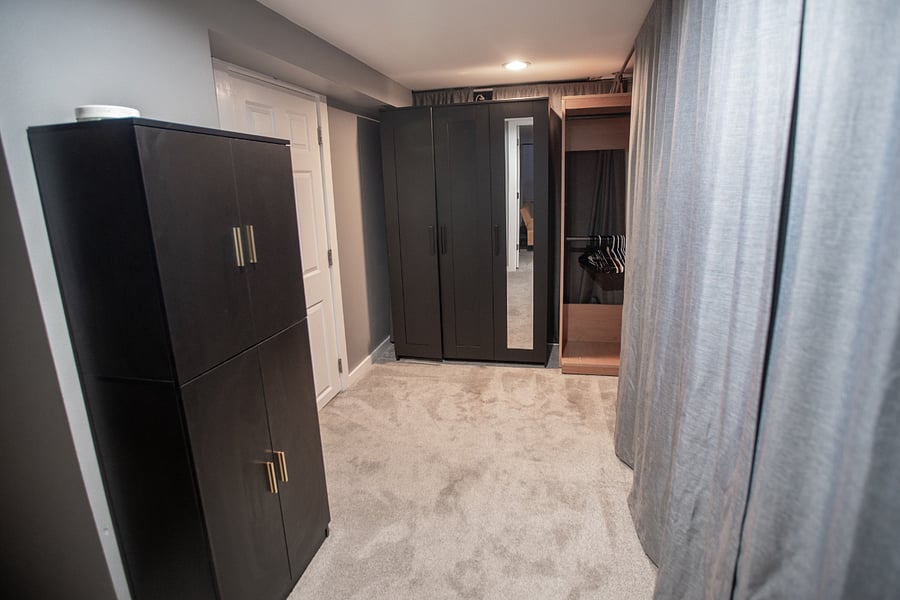 This is the area you enter after coming down the steps into the apartment. It includes tons of storage, dressers and armoires for clothing. The white door goes to the 100 square foot bathroom and laundry. 