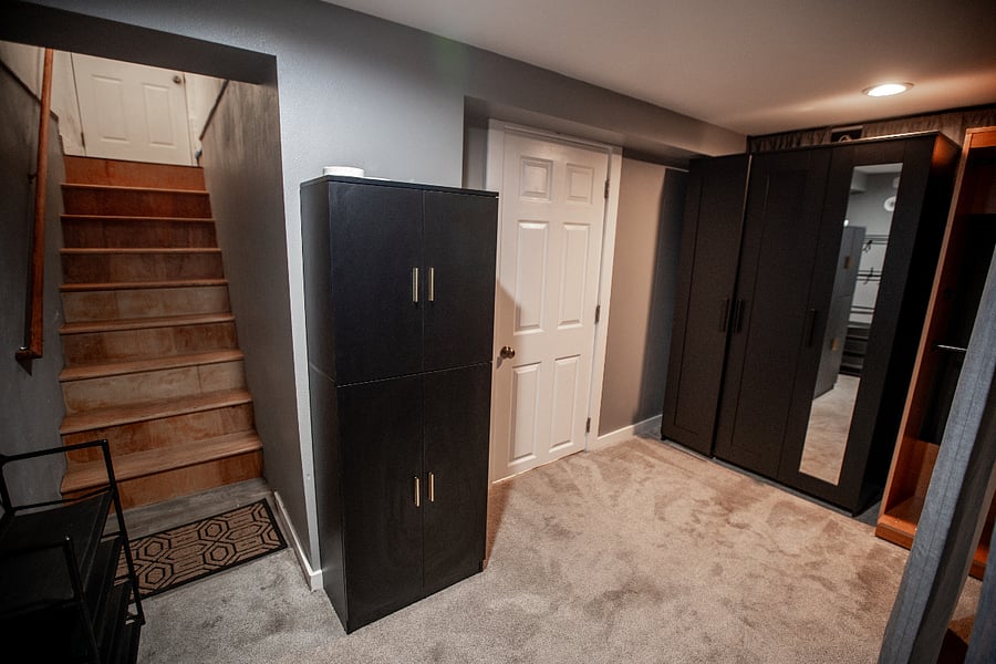 This is the area you enter after coming down the steps into the apartment. It includes tons of storage, dressers and armoires for clothing. The white door goes to the 100 square foot bathroom and laundry. 