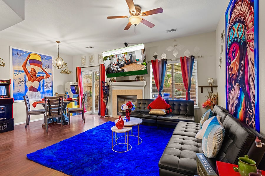 Spacious and eclectic living room with a cozy fireplace and plenty of seating. Perfect for entertaining guests or relaxing with family.