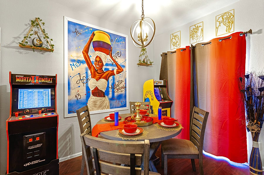Fun and vibrant dining area with a retro arcade game and colorful decor. Perfect for family meals and game nights.