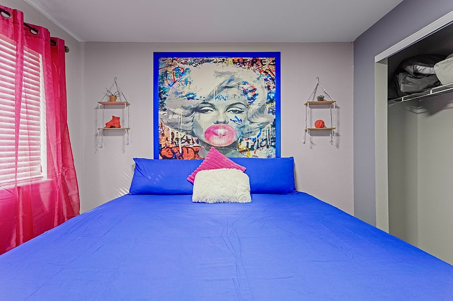 Bright and airy bedroom with a comfortable king-size bed and colorful decor. Perfect for a restful night's sleep.