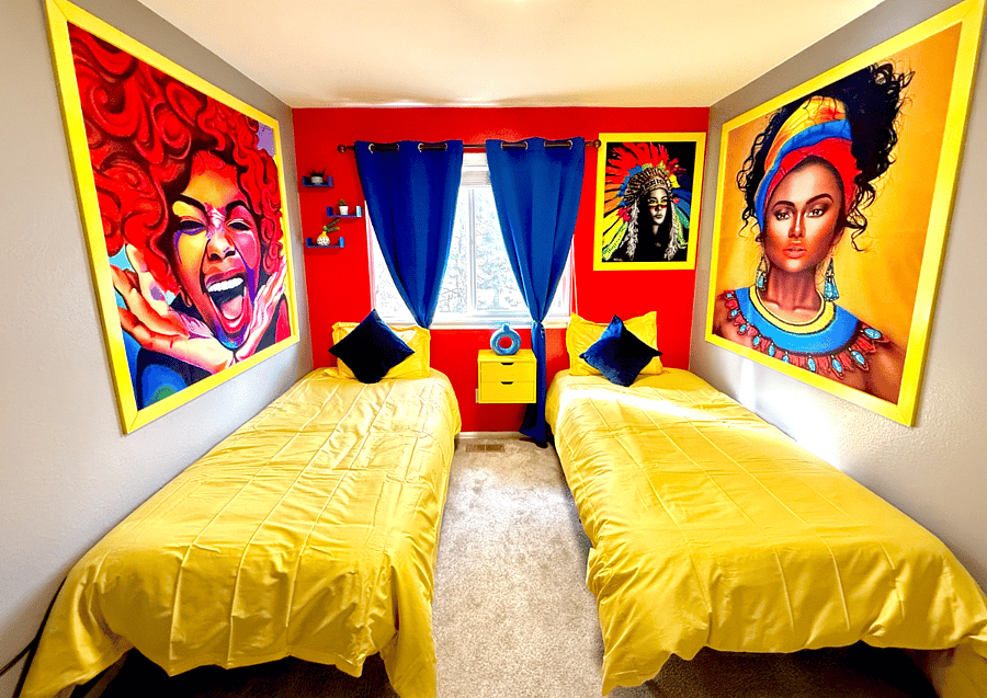 A bright and colorful twin bedroom adorned with vibrant artwork and yellow bedding, ideal for relaxation.
