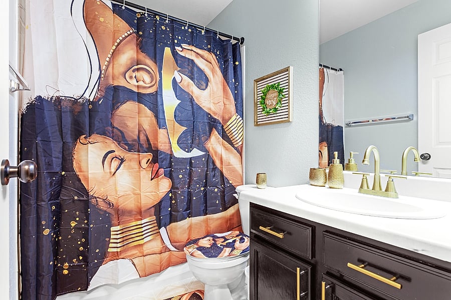 Spa-like bathroom with a modern vanity and a touch of artistic flair. Perfect for unwinding after a long day.