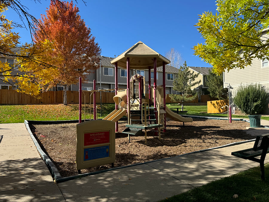 Explore endless fun at this spacious playground, featuring a charming little house with slides, a vibrant play area, and a comfortable sitting space for parents to relax while the kids enjoy their adventures.