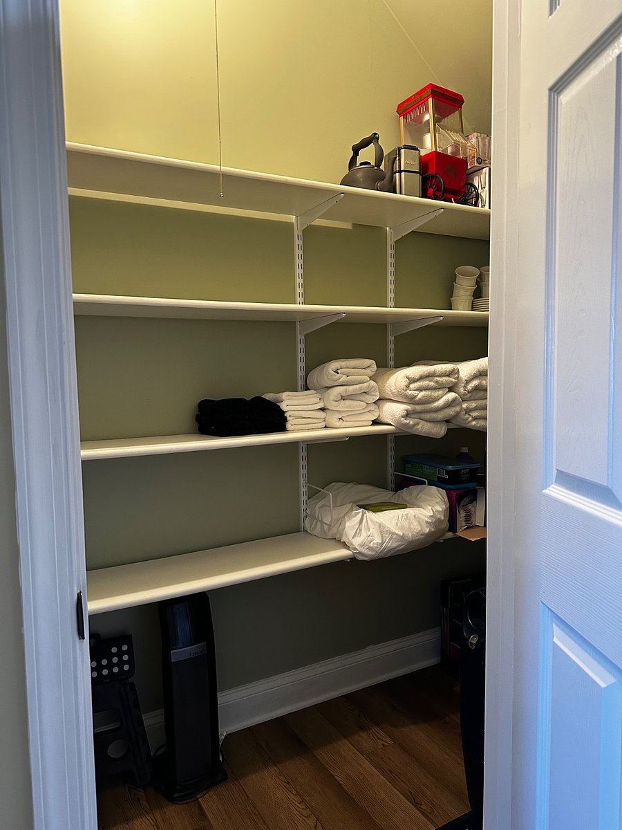 Hall closet with lots of storage.