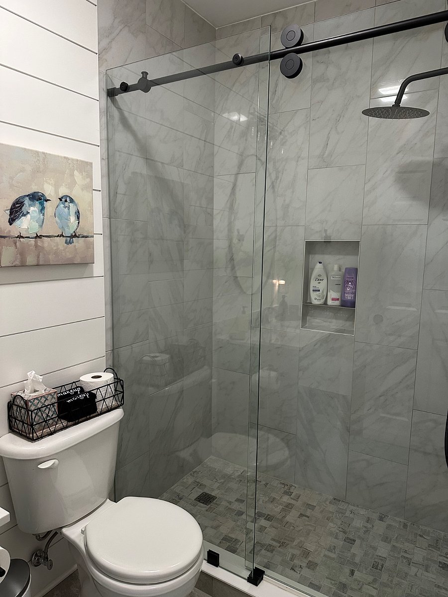Tiled shower with rain shower head.