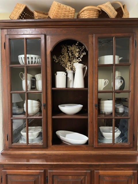 Stocked with four place settings of white Crate and Barrel dishes.