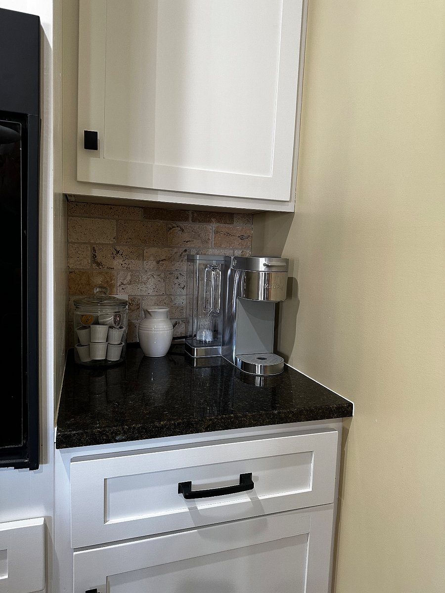Coffee center with Kuerig coffee maker (also includes a drip coffee maker) and stocked with tea and condiments.